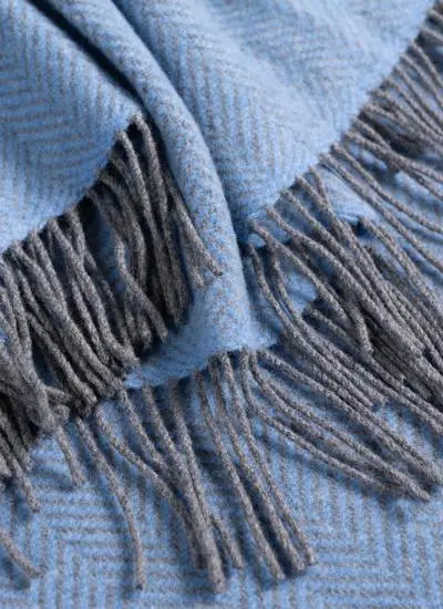blue grey herringbone pattern cashmere wool throw close up