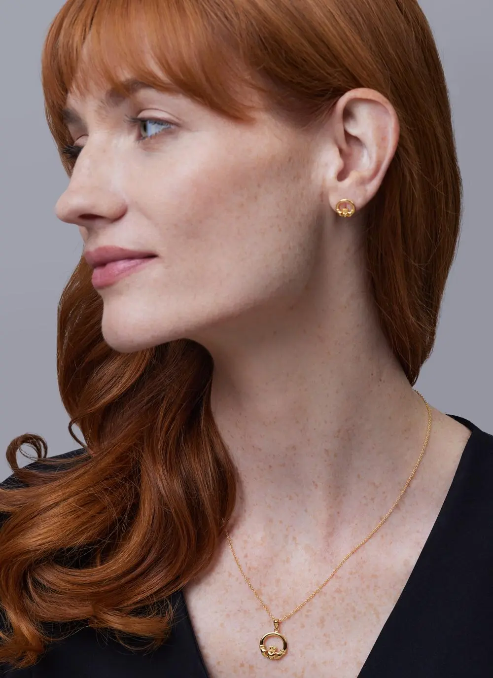 Red haired model wearing 14ct Gold Vermeil Claddagh Stud Earrings with matching pendant