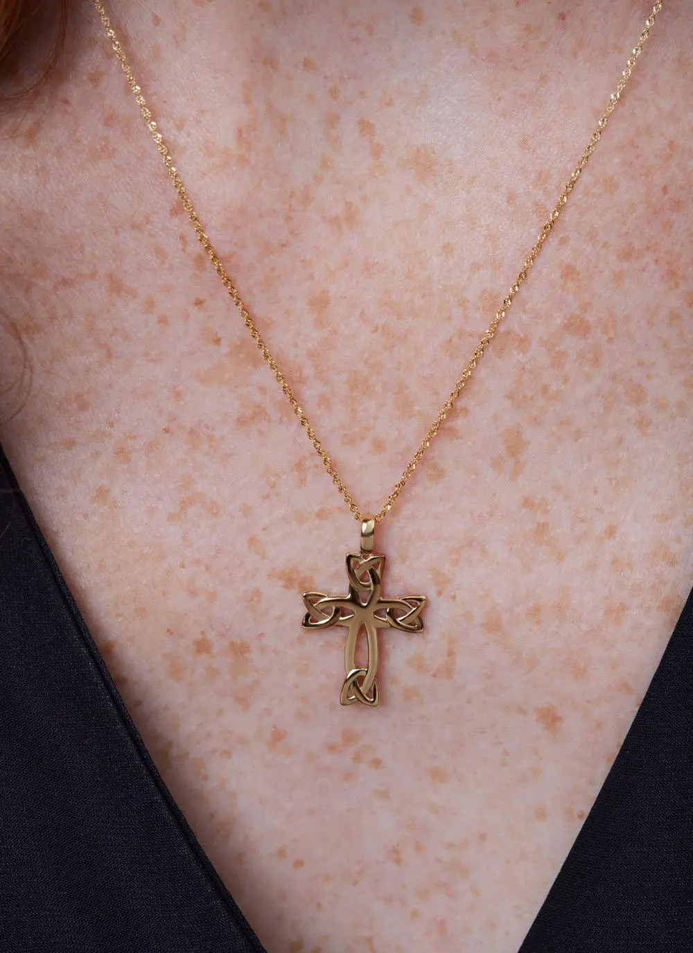 Decolletage shot of 14ct Gold Celtic Cross Trinity Knot Pendant