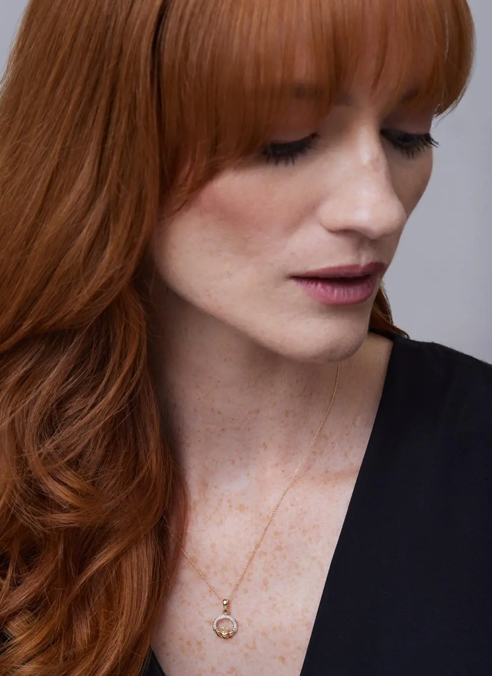 Red haired model wearing 14ct Gold Vermeil Claddagh Pendant with Cubic Zirconia