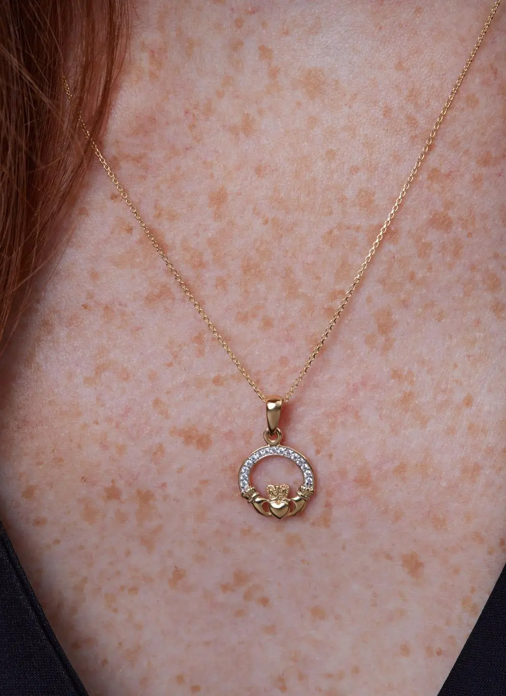 Decolletage shot of 14ct Gold Vermeil Claddagh Pendant with Cubic Zirconia