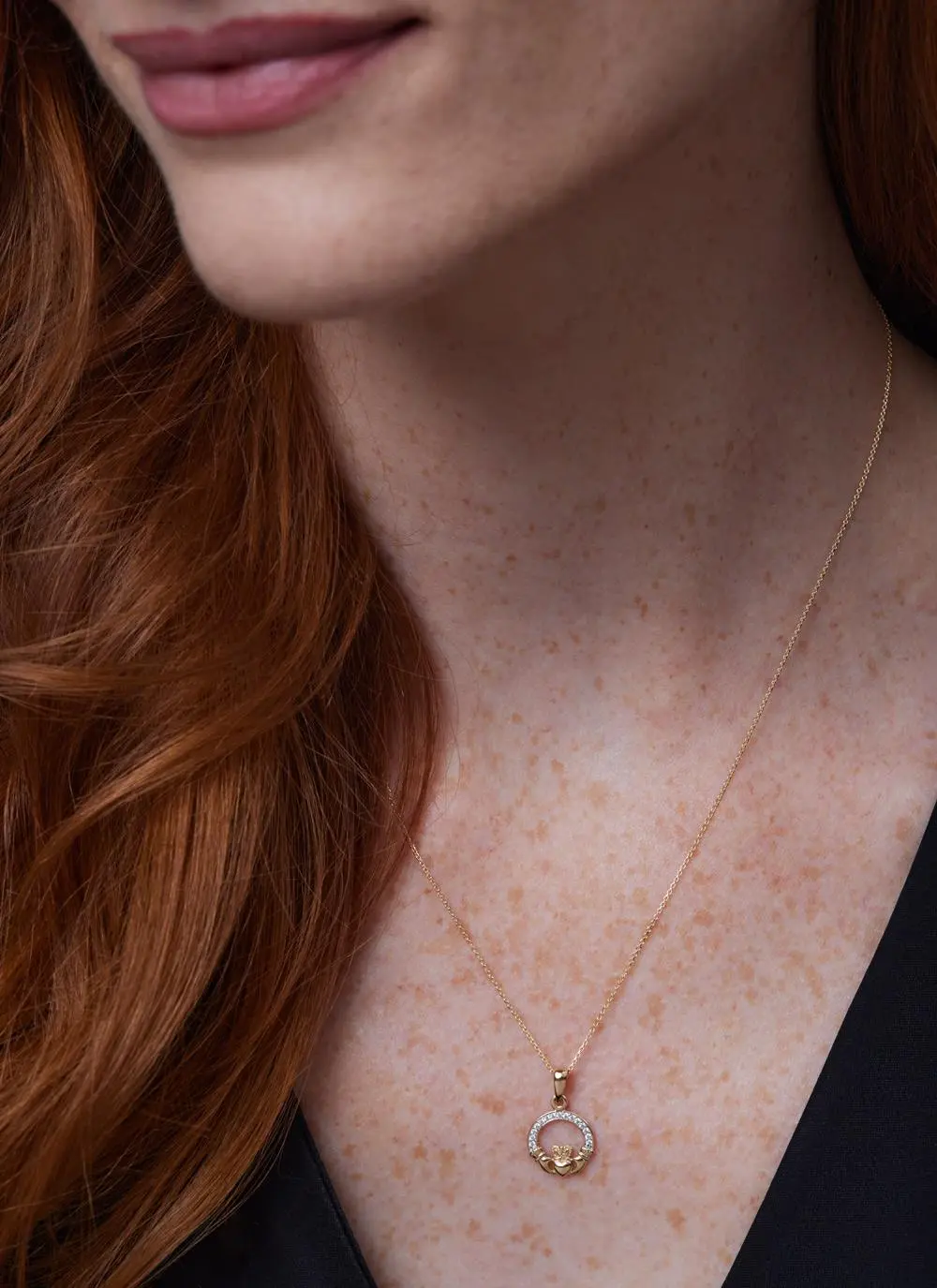 Close up shot of red haired model wearing 14ct Gold Vermeil Claddagh Pendant with Cubic Zirconia