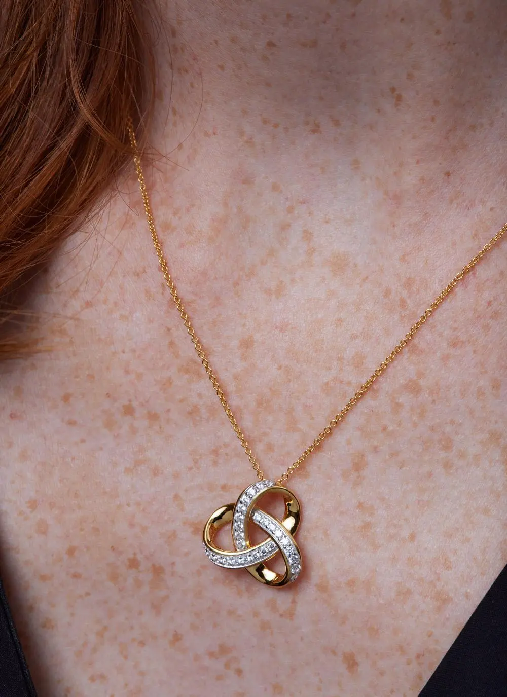 Décolletage shot of 14ct Gold Vermeil Trinity Knot Pendant with Cubic Zirconia