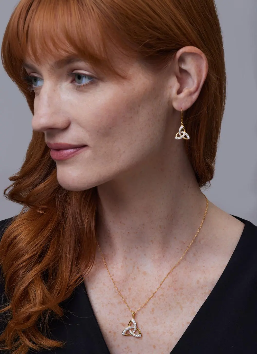 Red haired model wearing 14Ct Gold Vermeil Trinity Knot Drop Earrings with Cubic Zirconia with matching earrings