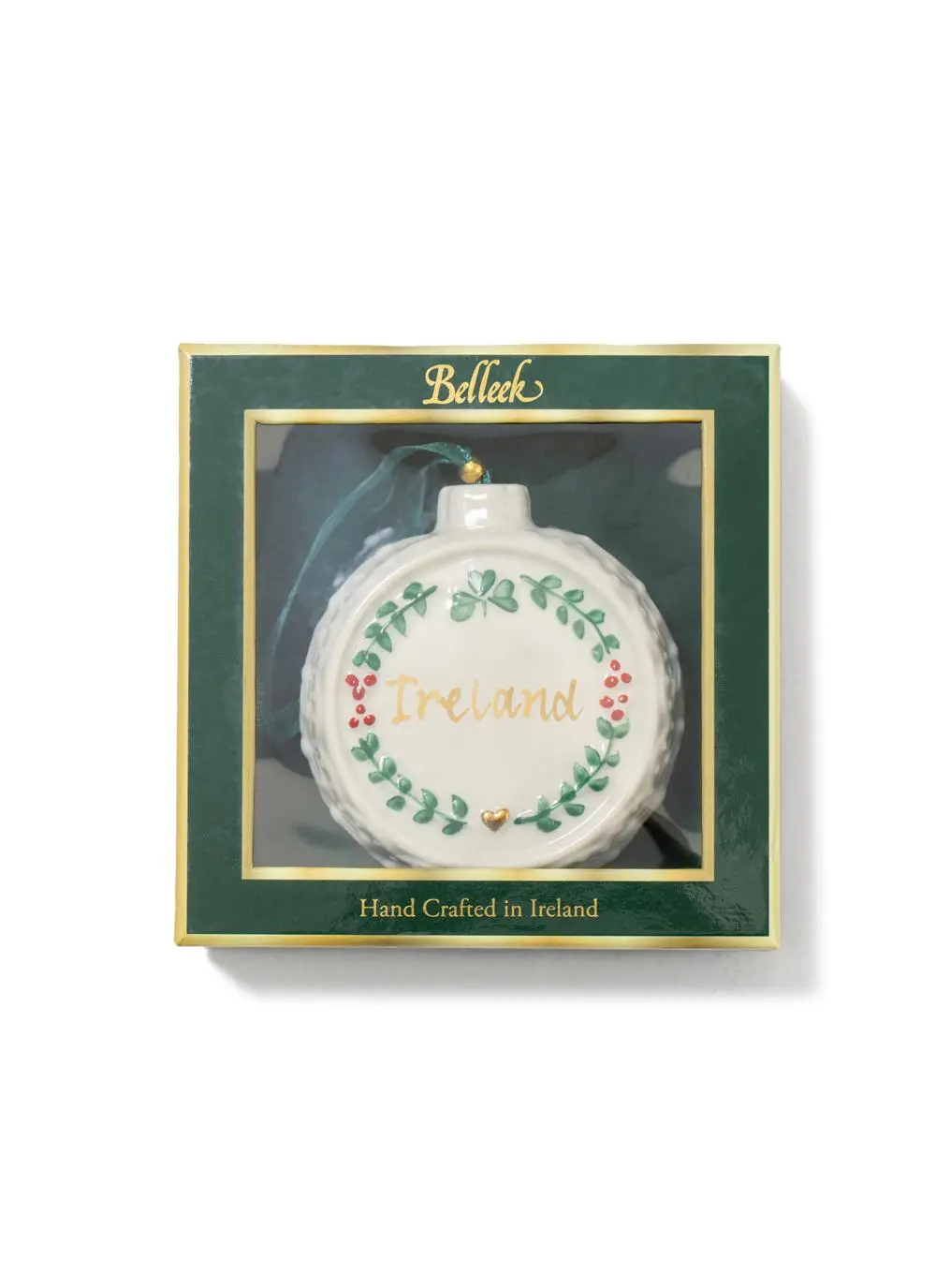 A round, ireland-themed christmas ornament featuring the word 