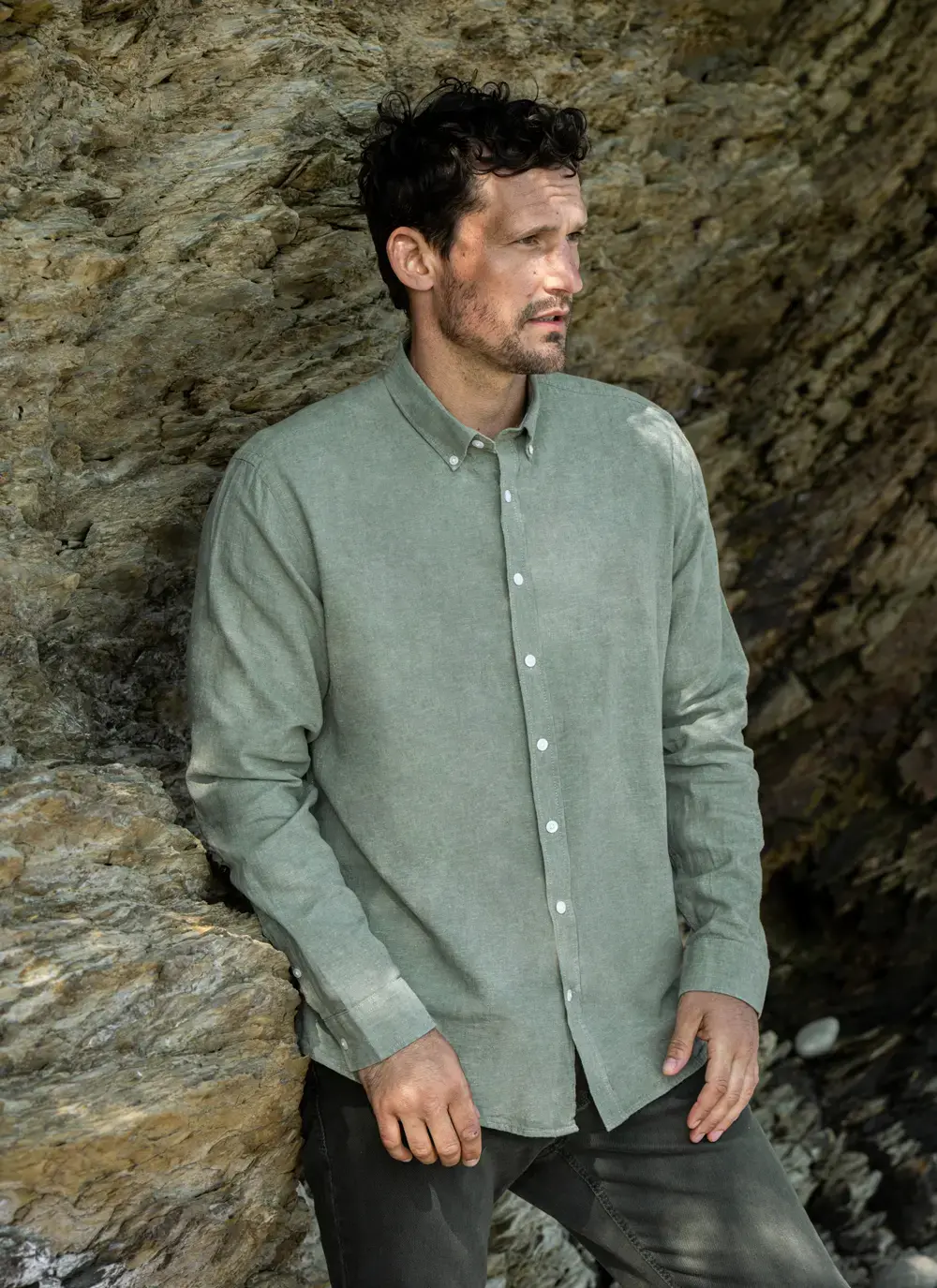 Close-up of model wearing Finn Cotton Linen Shirt in Green, showcasing button-down collar and soft texture – timeless Irish design.