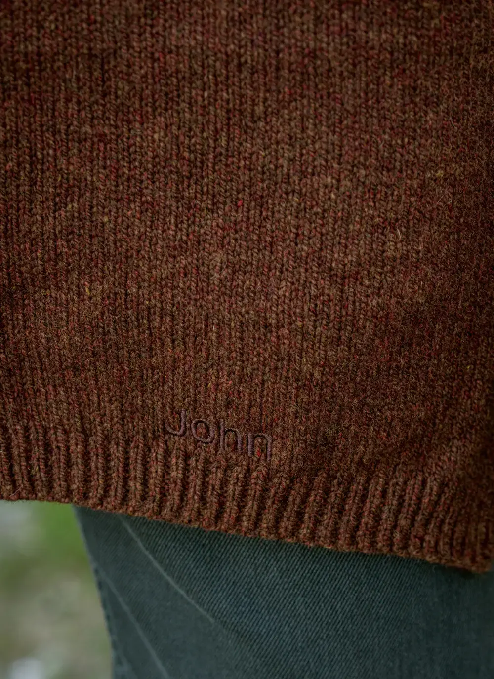 Personalized wool cashmere scarf in chestnut brown, made in Ireland, worn with rust sweater in forest backdrop