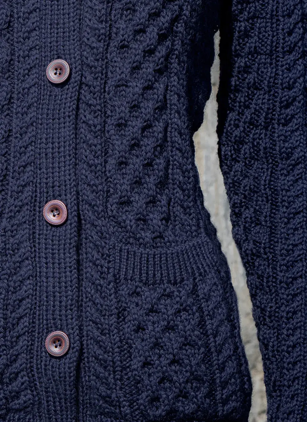 Close up of red head model sleeve detail buttons trellis stitch