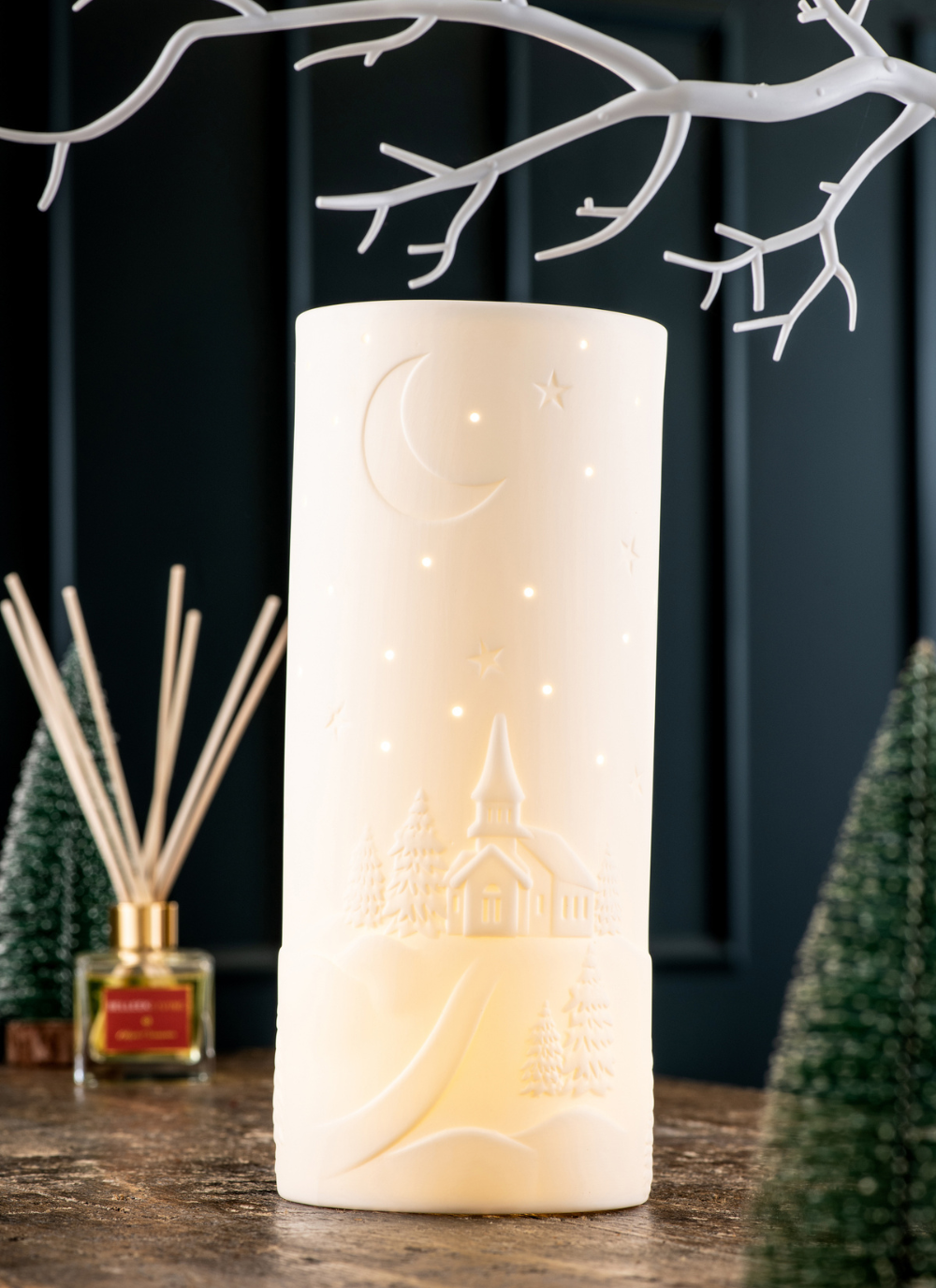 A church, moon and stars depicted on a luminaire