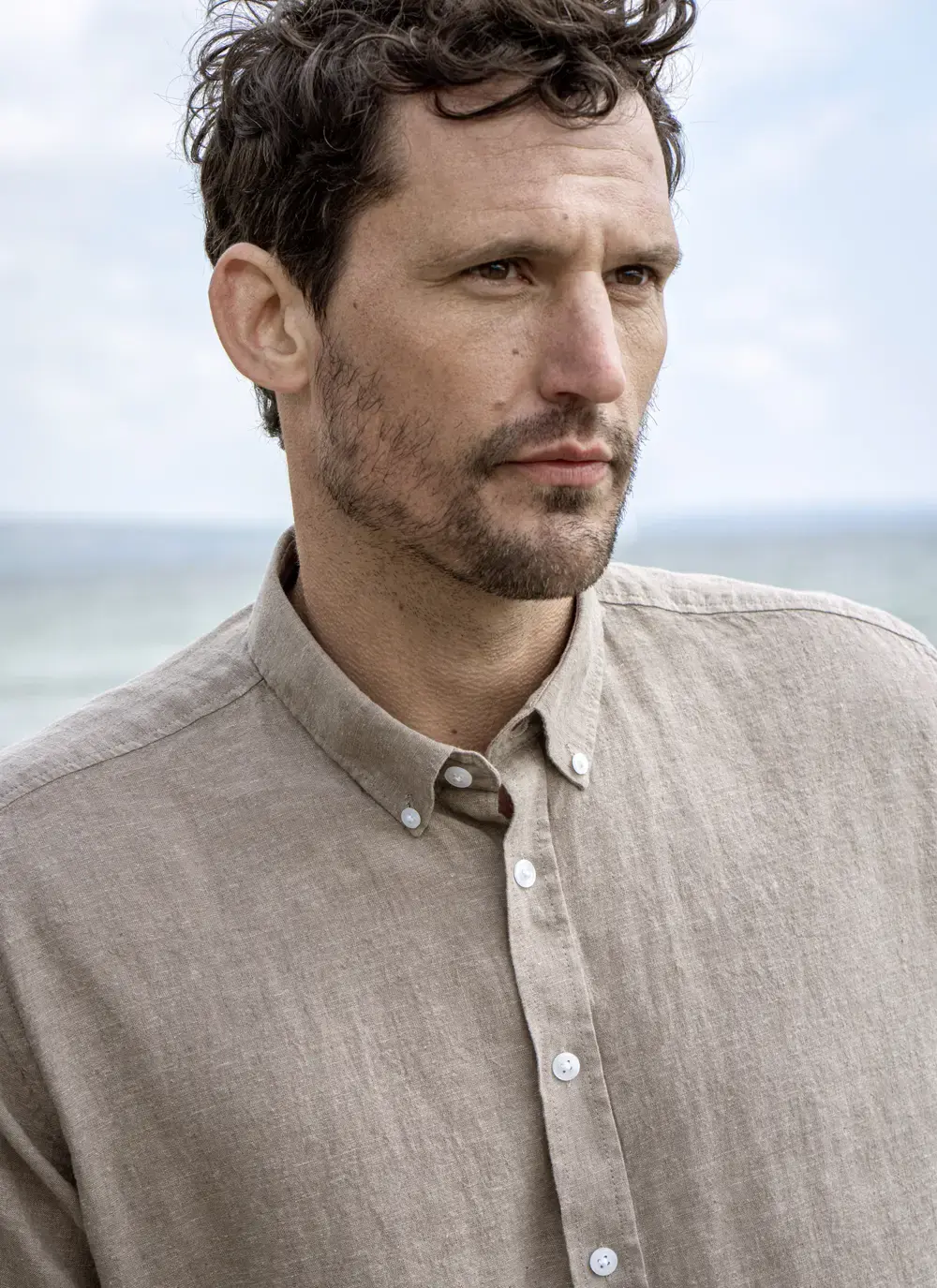 Close-up portrait of man wearing Finn cotton linen shirt, looking serious