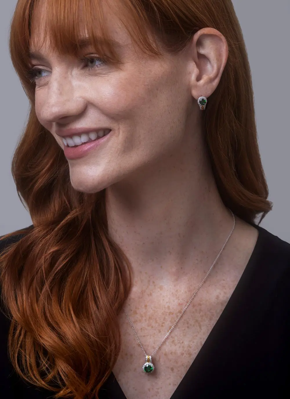 Red haired model wearing Celtic Silver Green Stone Halo Pendant with matching earrings 