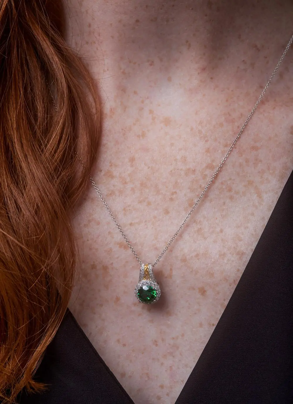 Décolletage shot of red haired model wearing Celtic Silver Green Stone Halo Pendant
