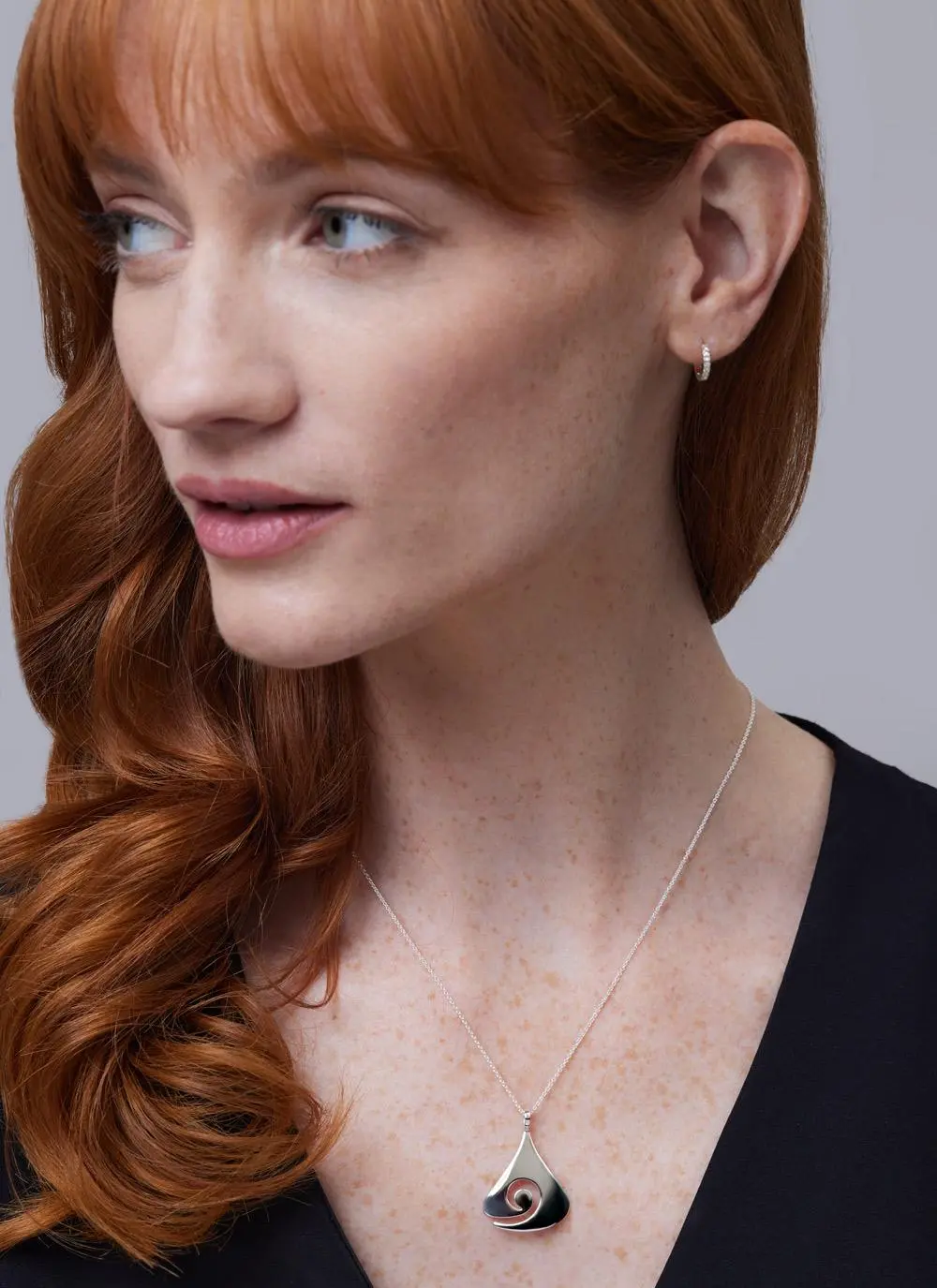 Red haired model wearing Sterling Silver Contemporary Celtic Swirl Pendant