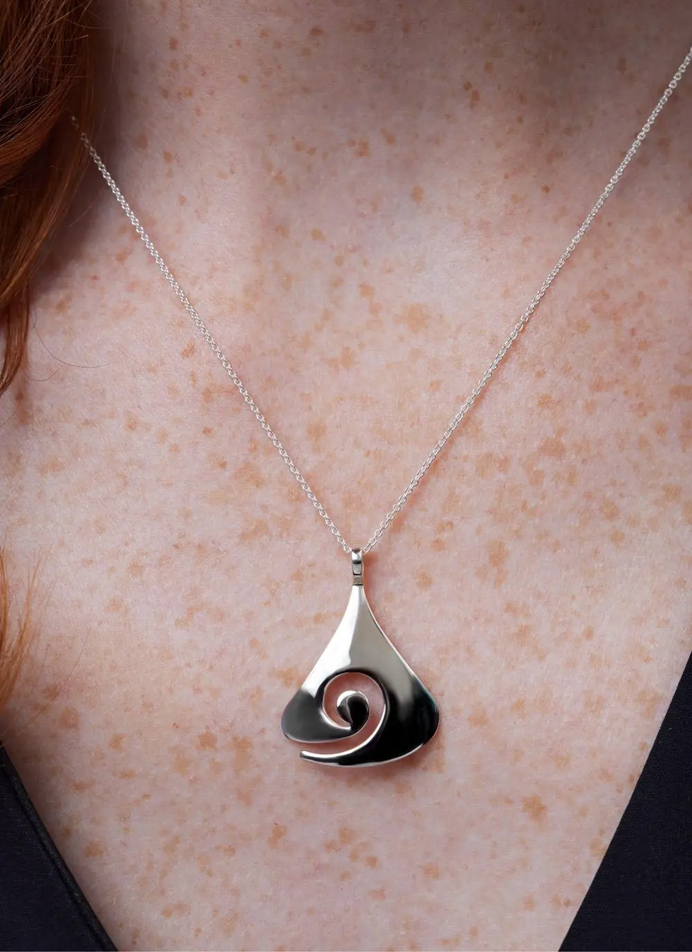Decolletage shot of Sterling Silver Contemporary Celtic Swirl Pendant