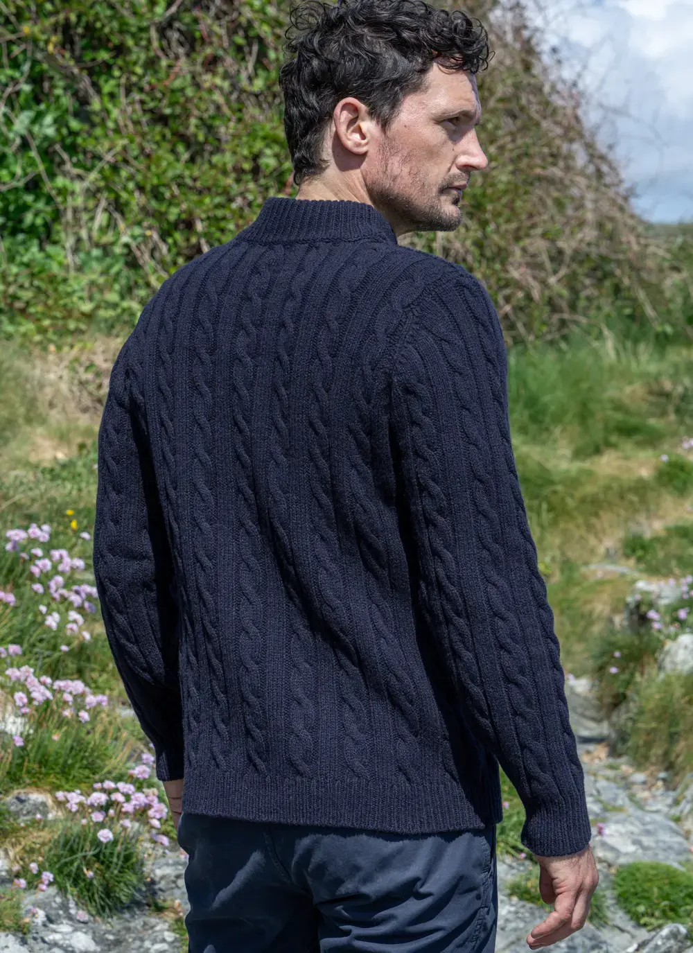Back view of navy Fisherman Mock Neck Sweater showing full cable design and soft knit texture.