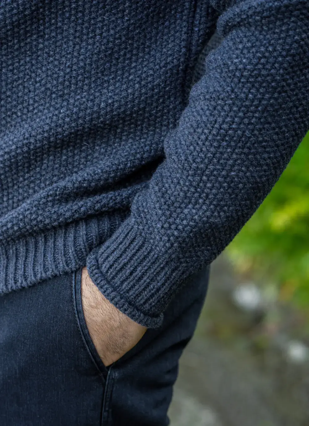 Detailed close-up of ribbed cuff and knit texture on the sweater