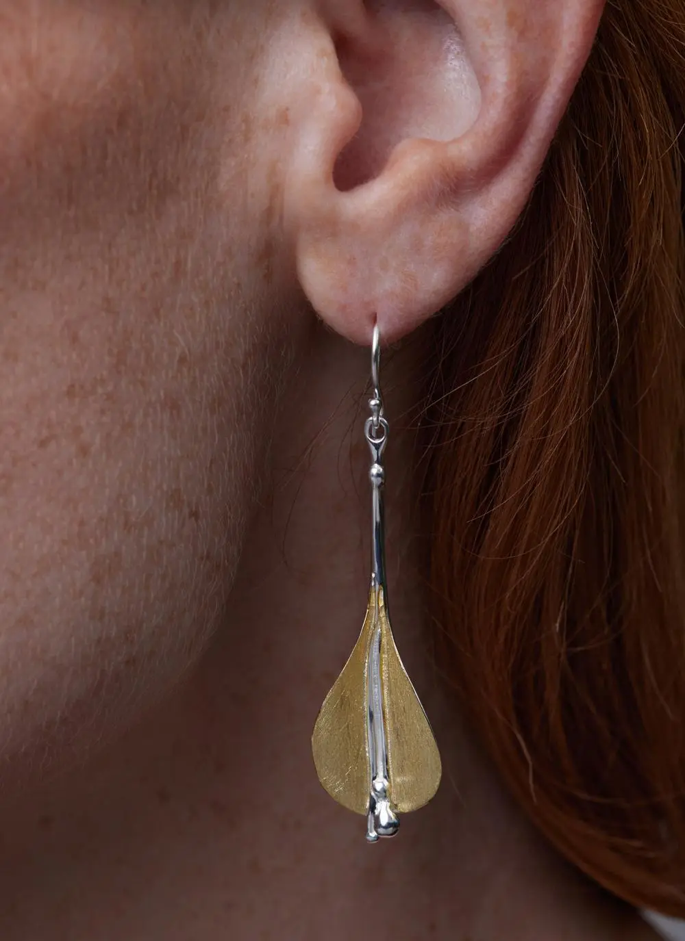 Close up of red haired model wearing Gold Vermeil Two Tone Lily Earrings