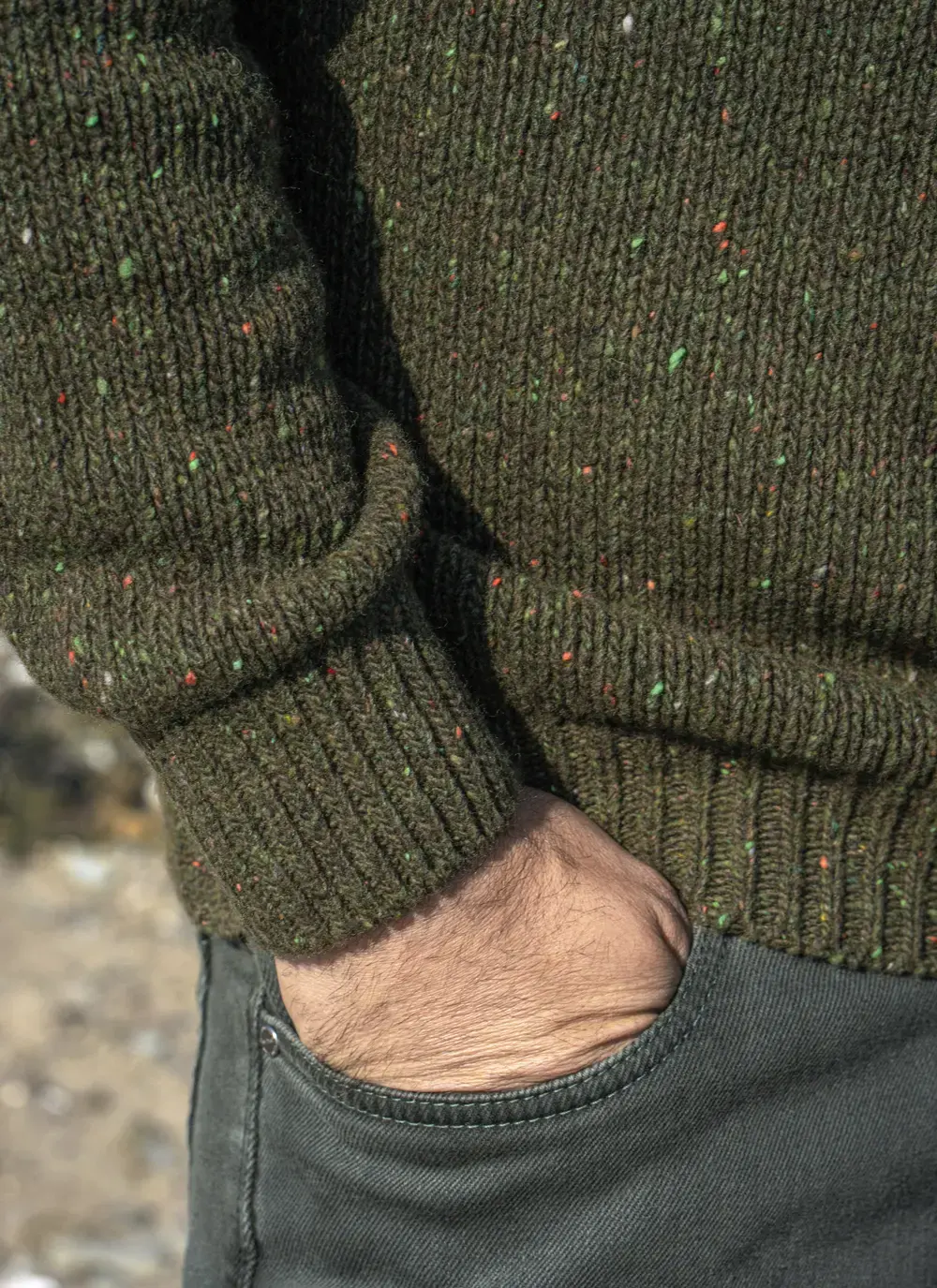 Detail shot of sleeve and hem on Glenstone 1/2 Zip Sweater, showing ribbed cuff and speckled yarn pattern.