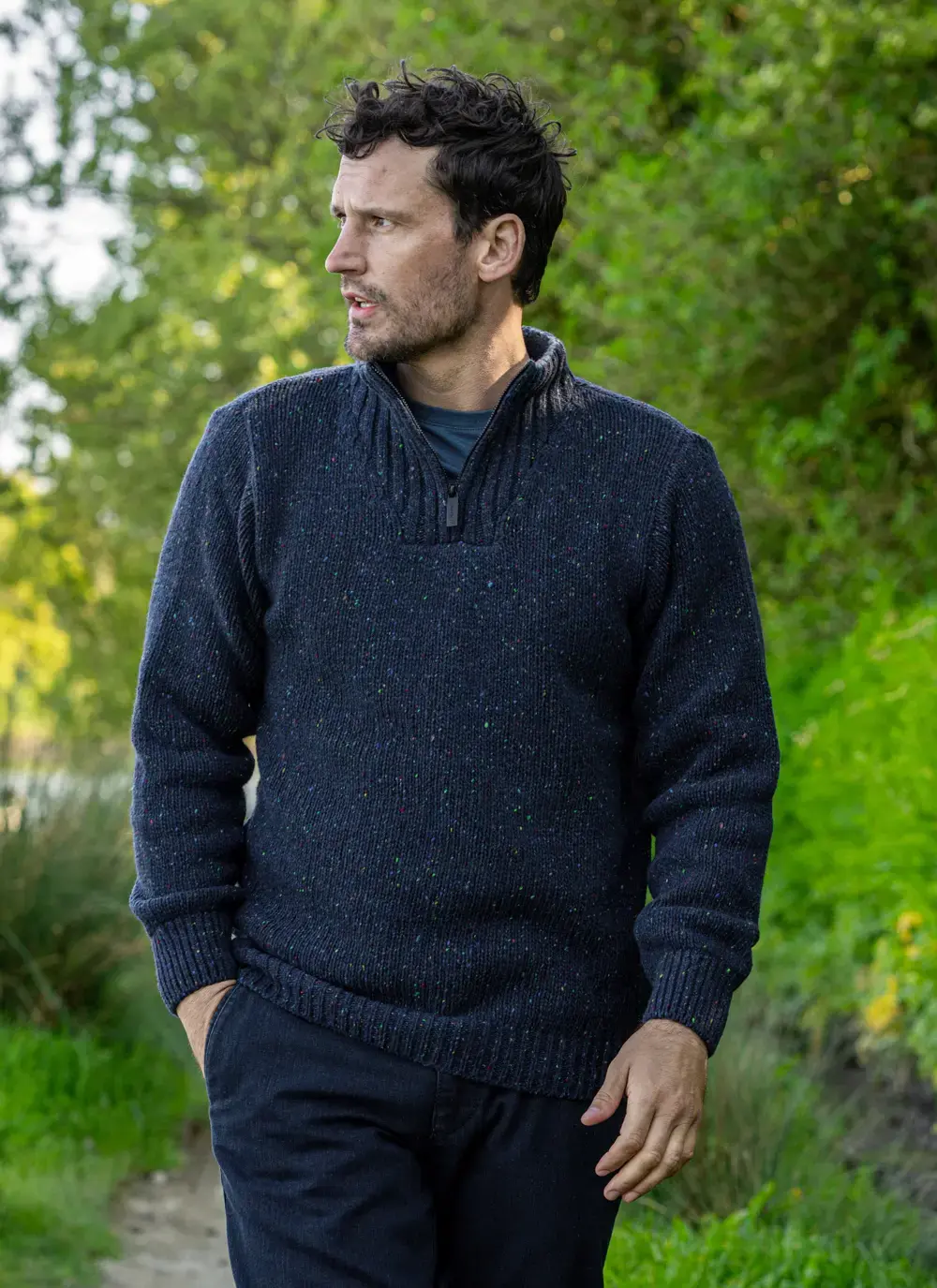 Man wearing navy Glenstone Contrast half zip sweater walking on nature path