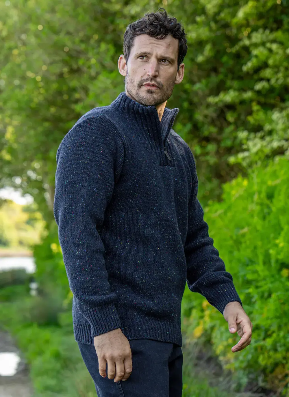 Man wearing navy Glenstone Contrast half zip sweater walking on nature path