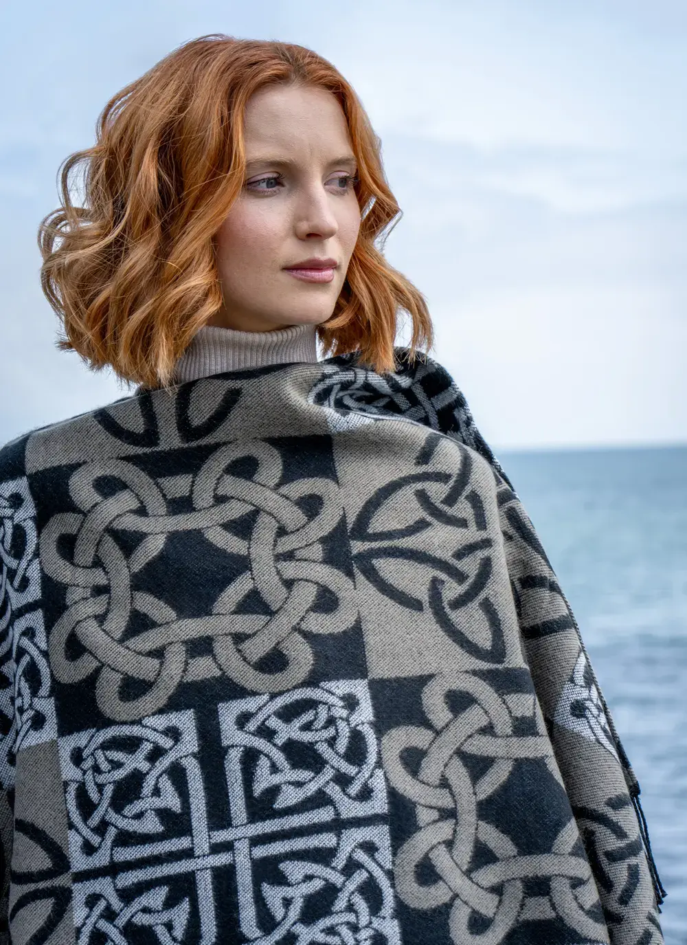 Close up of red head model in black celtic knot shawl