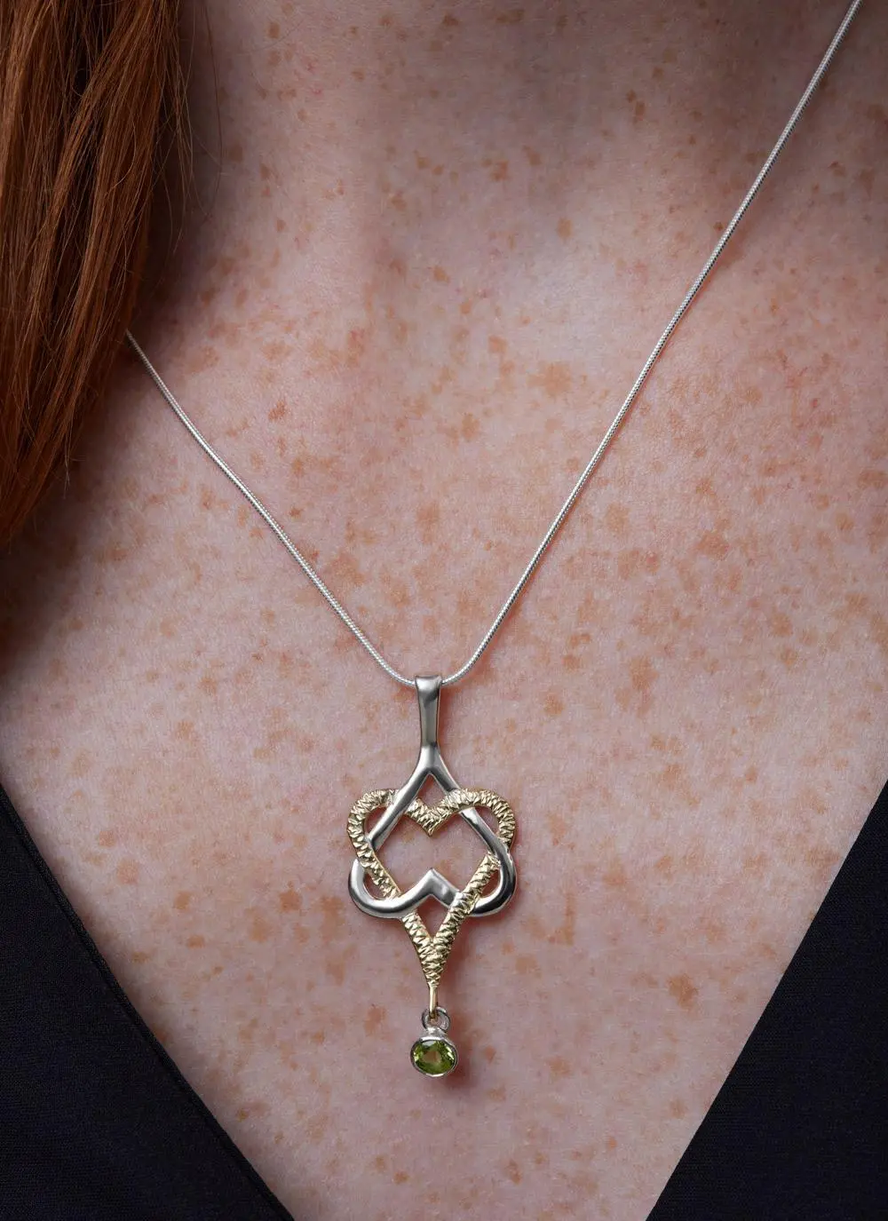 Décolletage shot of Mo Chroi Love Pendant