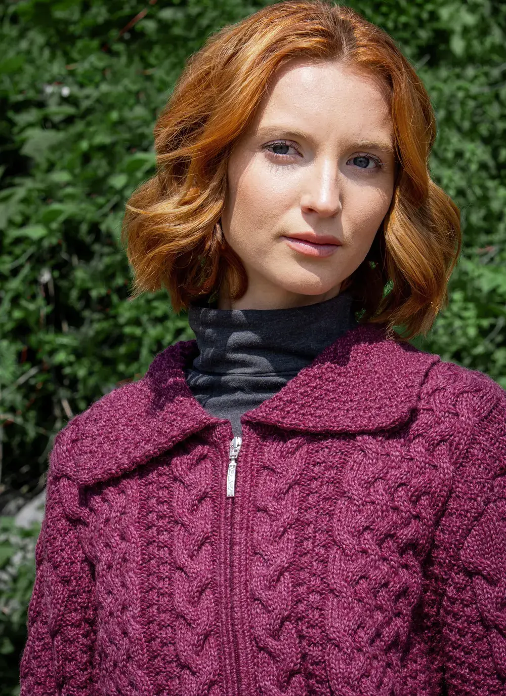 Close up of Red head model collar detail grace full zip aran cardigan in raspberry melange