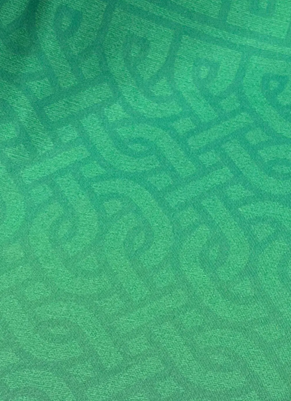 Green t-shirt with letters spelling Ireland and fighting Irish logo printed, navy sleeves, celtic print all over