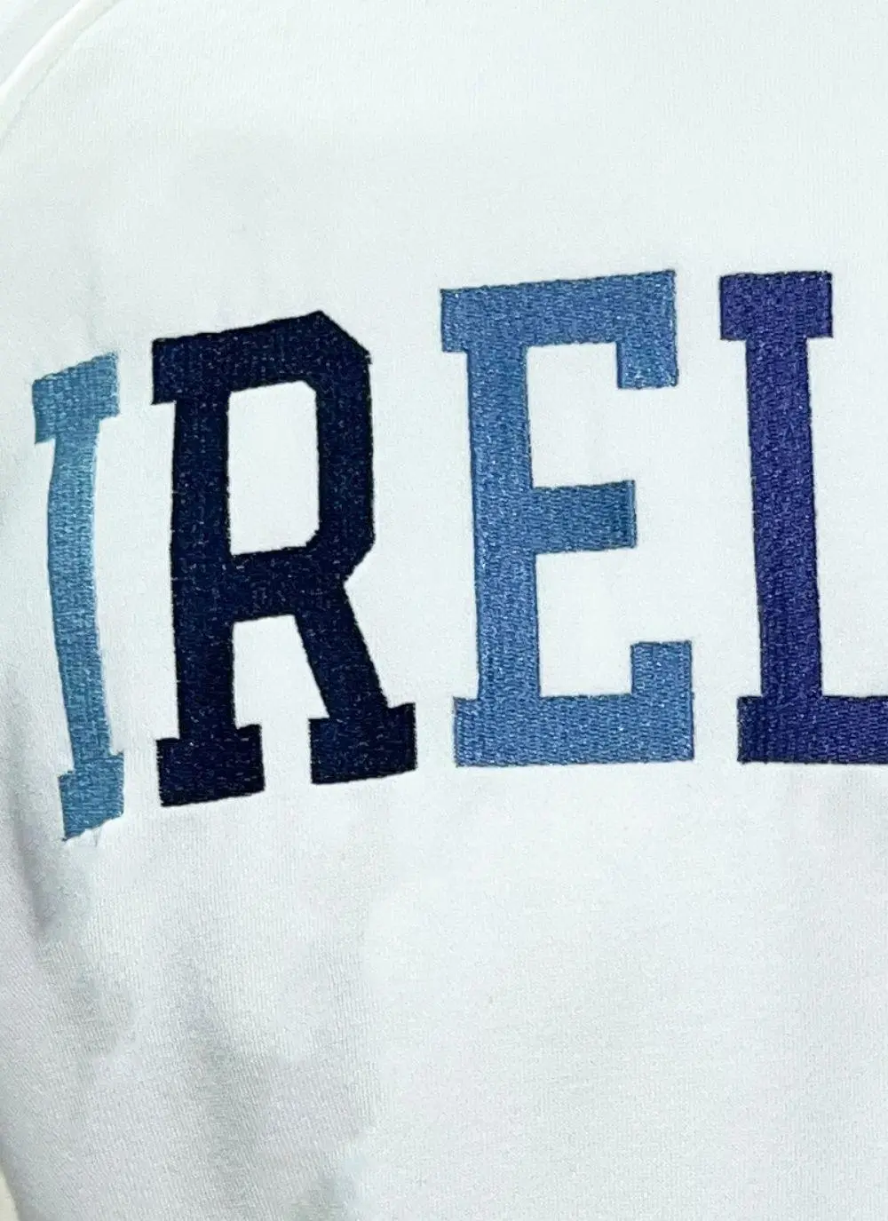 Cream sweatshirt with Ireland and fighting Irish logo in blue in the center