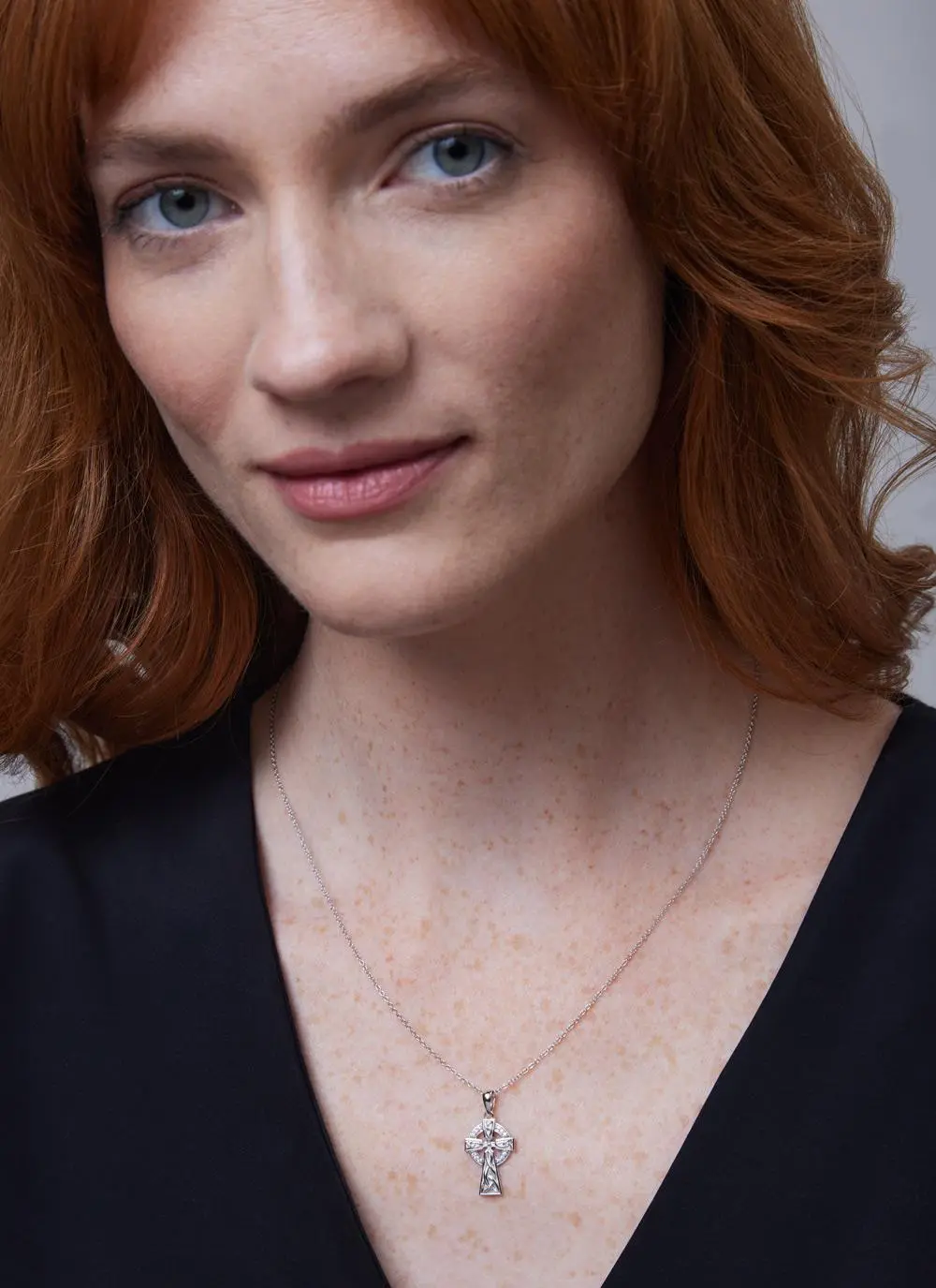 Head shot of red haired woman wearing Sterling Silver Celtic Stone Trinity Knot Sterling Silver Cross