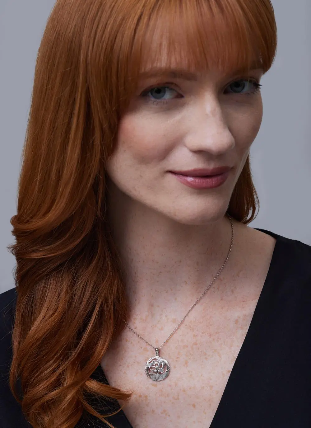 Red haired model wearing Sterling Silver Children Of Lir Pendant 