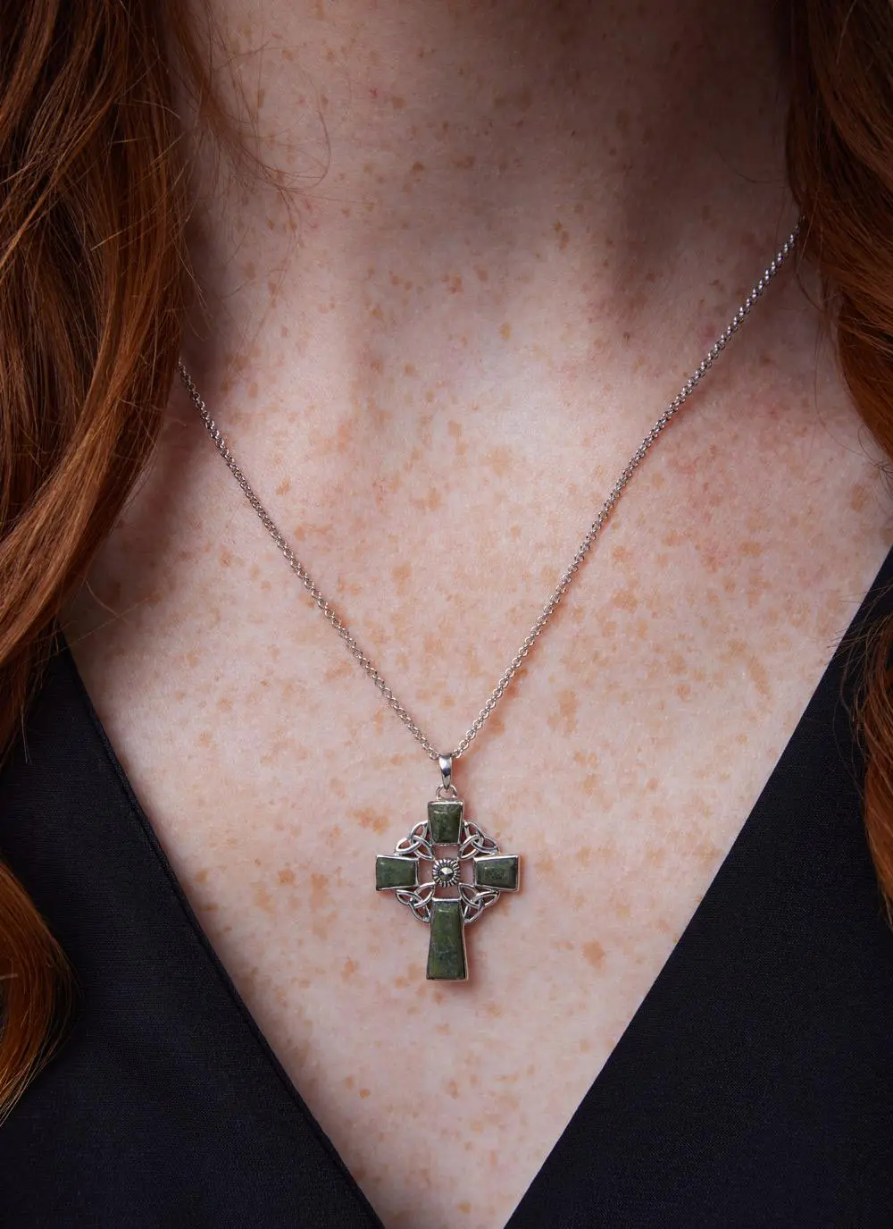 Décolletage shot of Sterling Silver Connemara Marble Celtic Cross Pendant