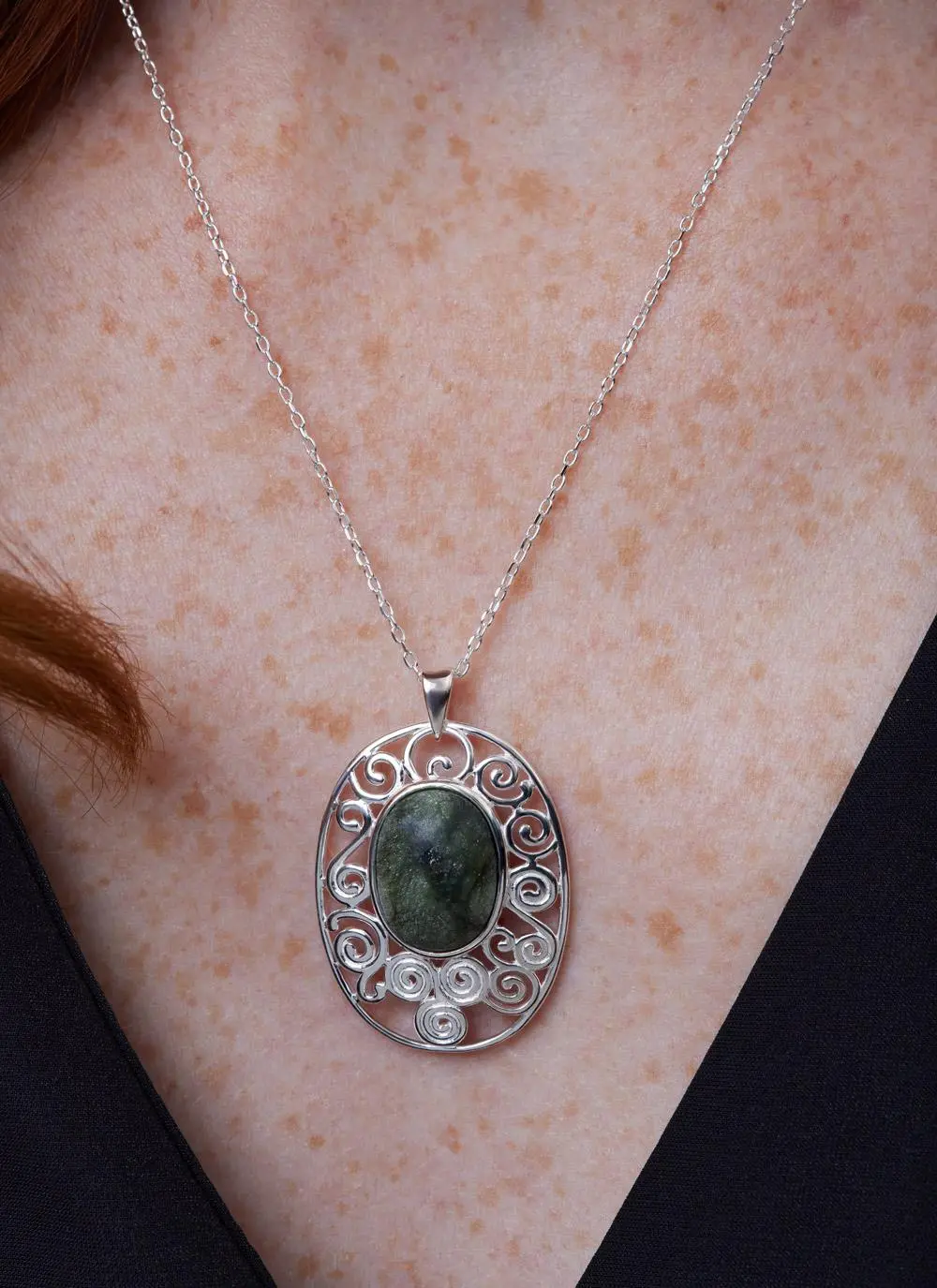 Decolletage shot of Sterling Silver Connemara Marble Newgrange Pendant