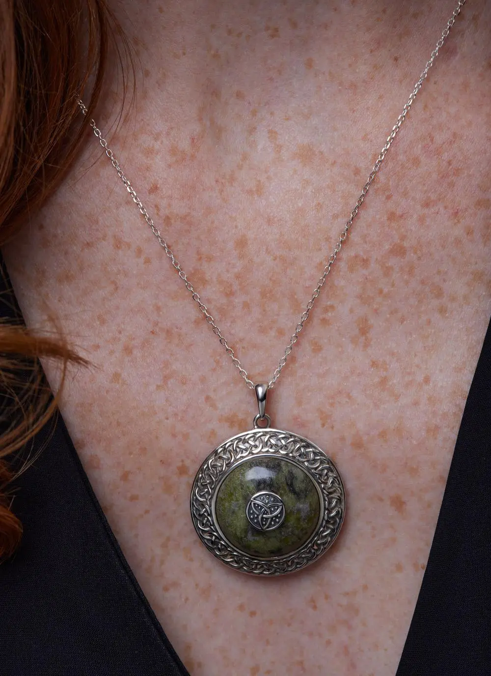 Decolletage shot of Sterling Silver Connemara Marble Trinity Dome Pendant