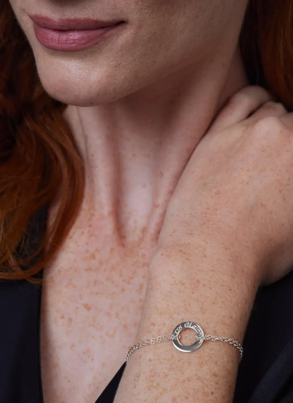 Close up shot of red haired model wearing Sterling Silver Croi Alainn Bracelet 