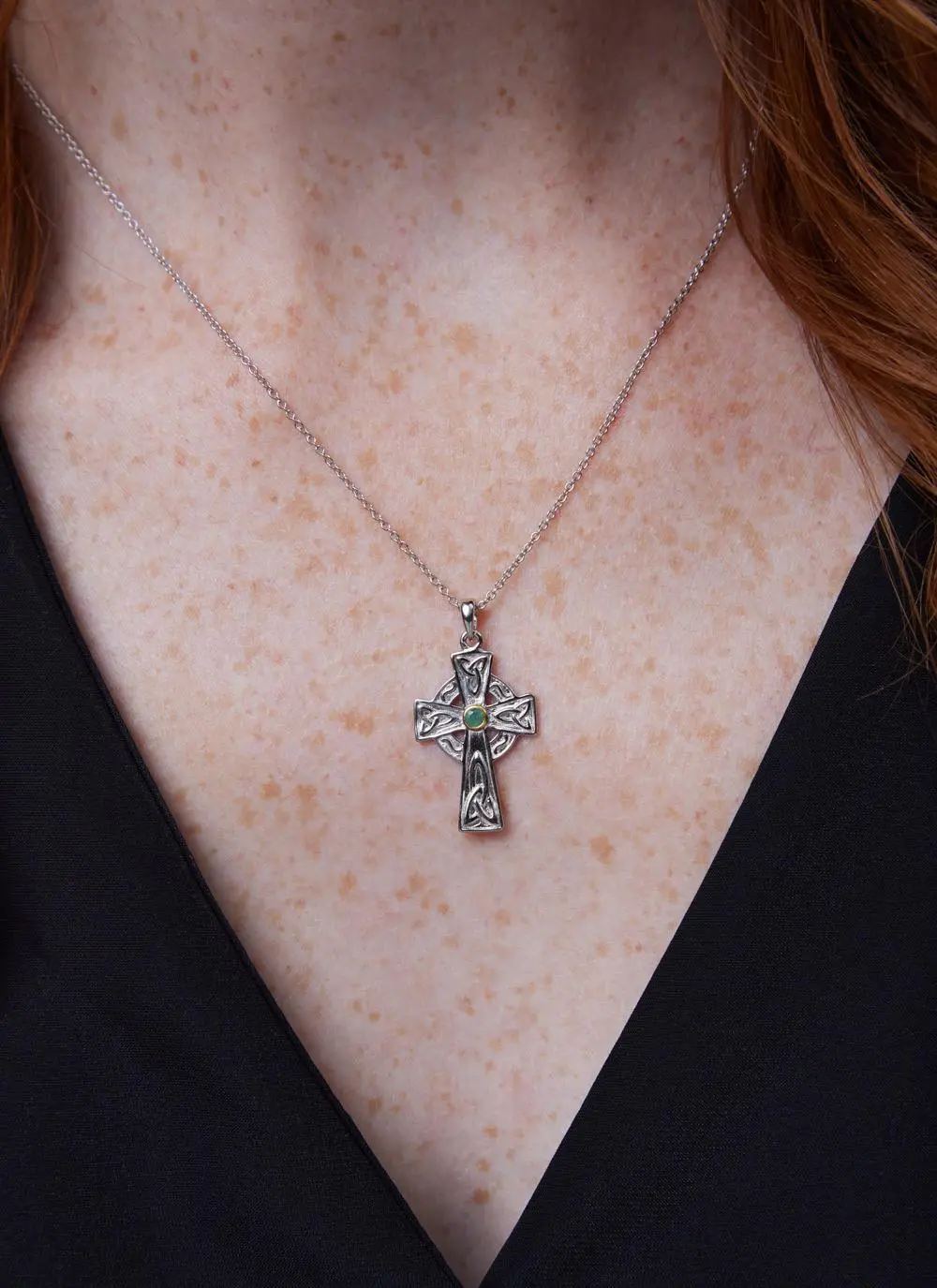 Décolletage shot of Sterling Silver Emerald Celtic Cross Pendant