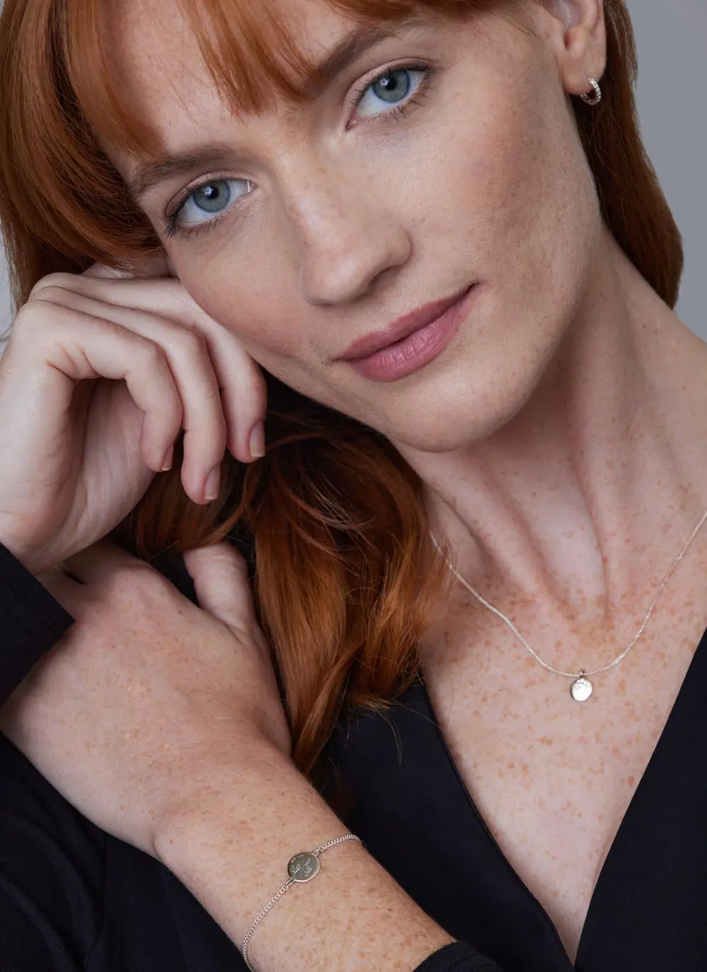 Red haired model wearing Sterling Silver Light My Way Diamond Bracelet with matching pendant