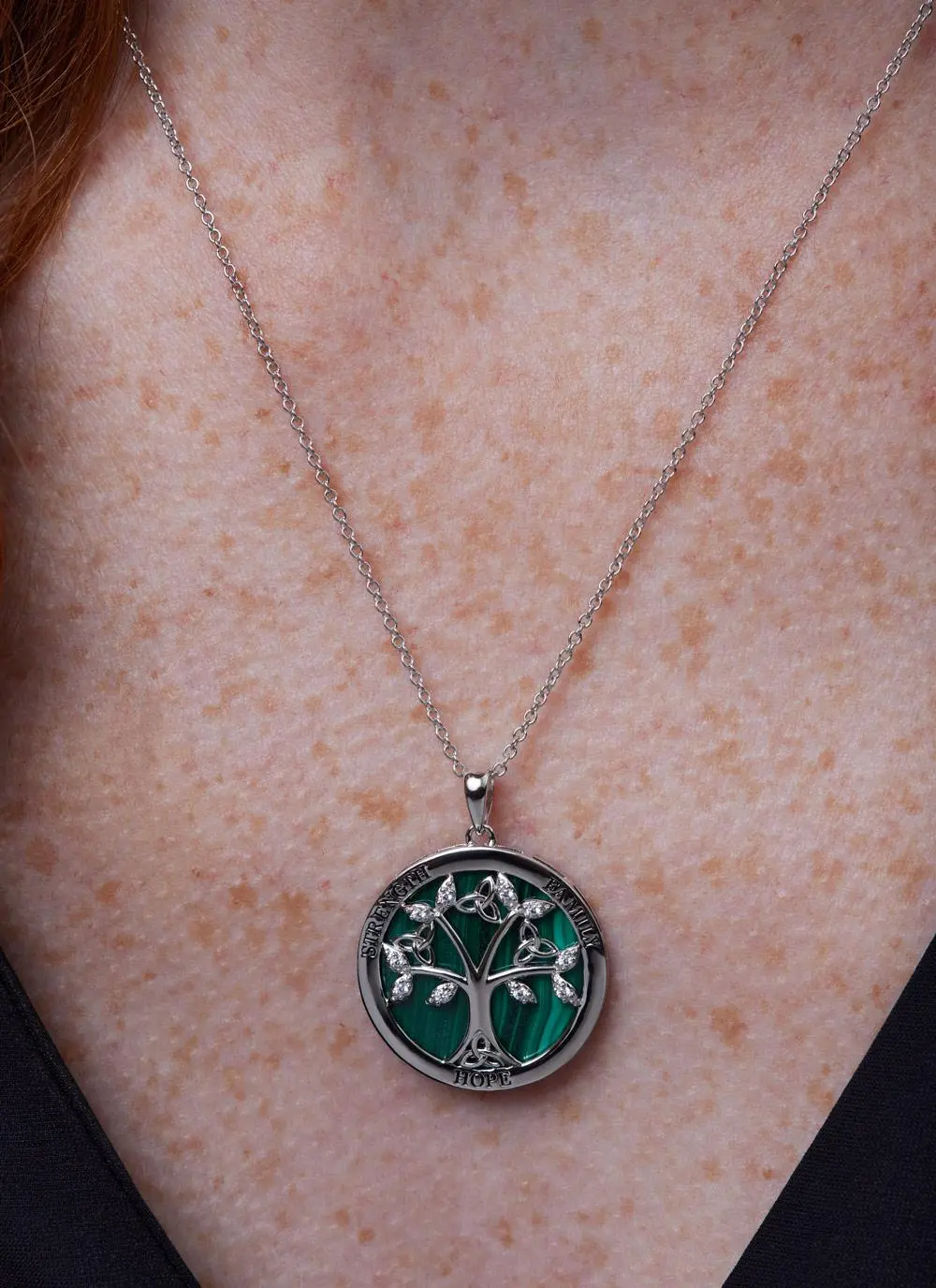 Décolletage shot of Sterling Silver Malachite Tree of Life Disc Pendant