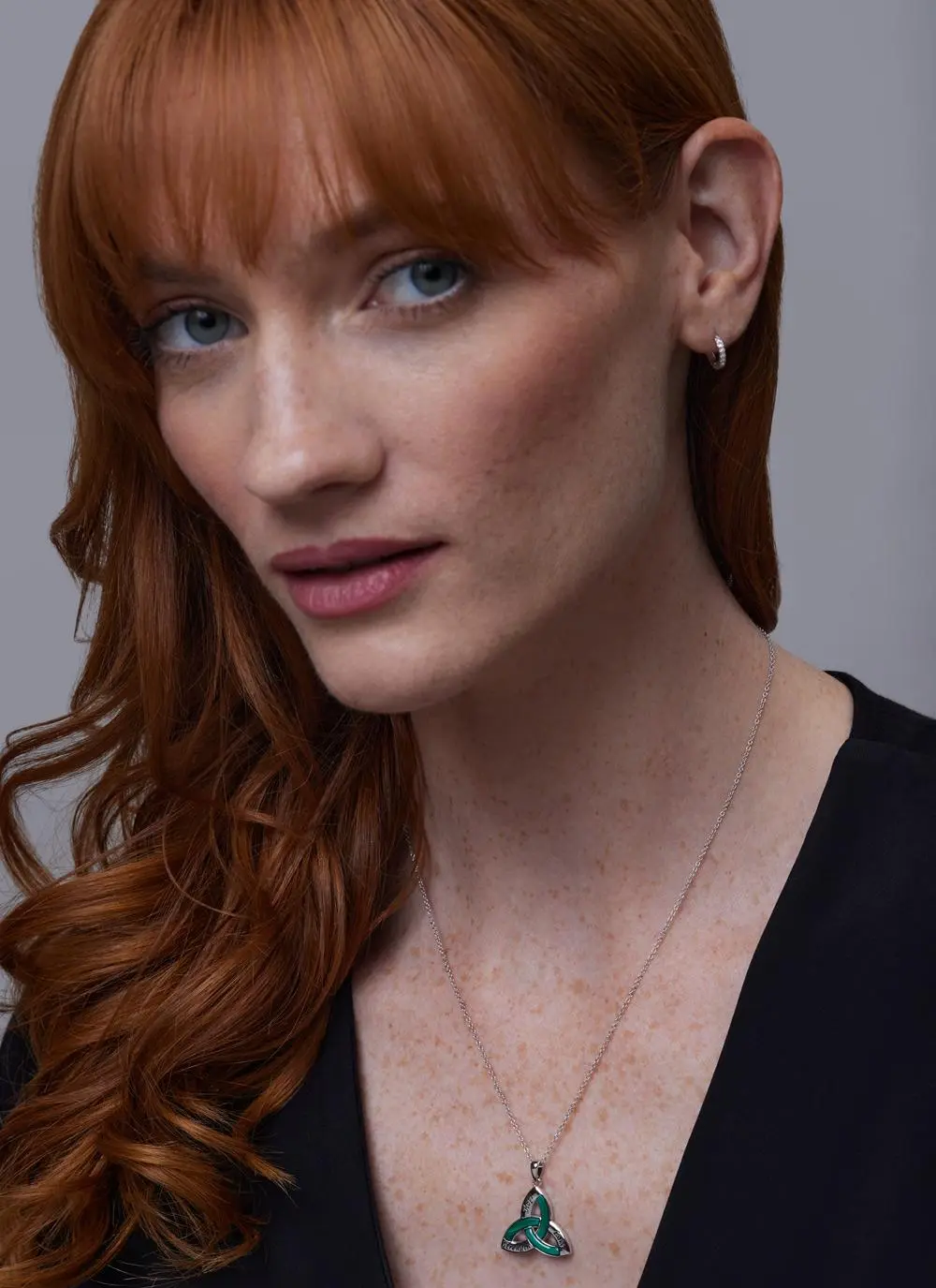 Red haired model wearing Sterling Silver Malachite Trinity Knot Pendant