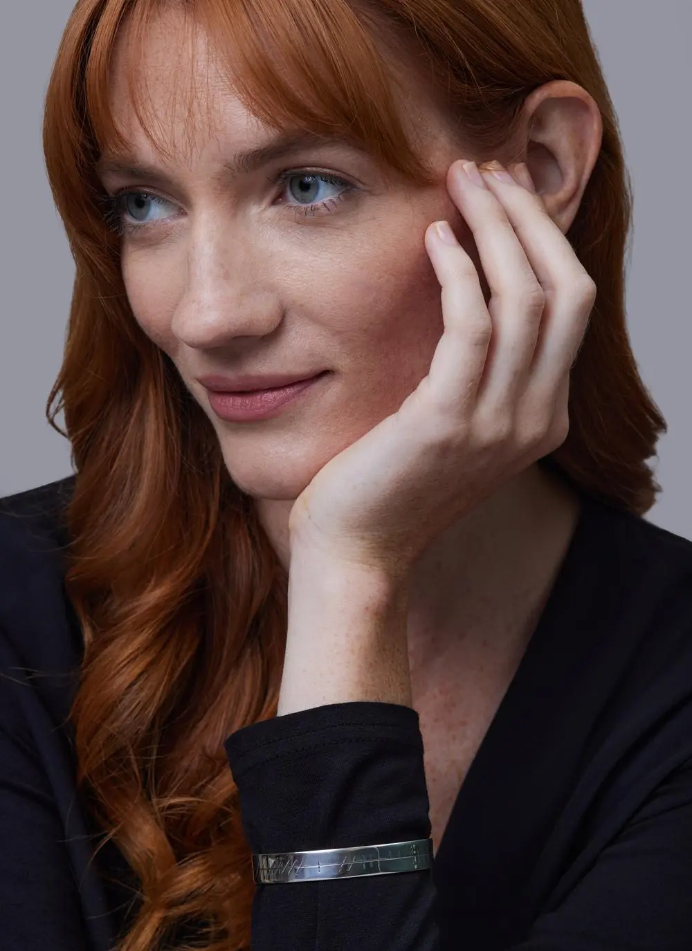 Red haired model wearing Sterling Silver Ogham Love Forever Bangle