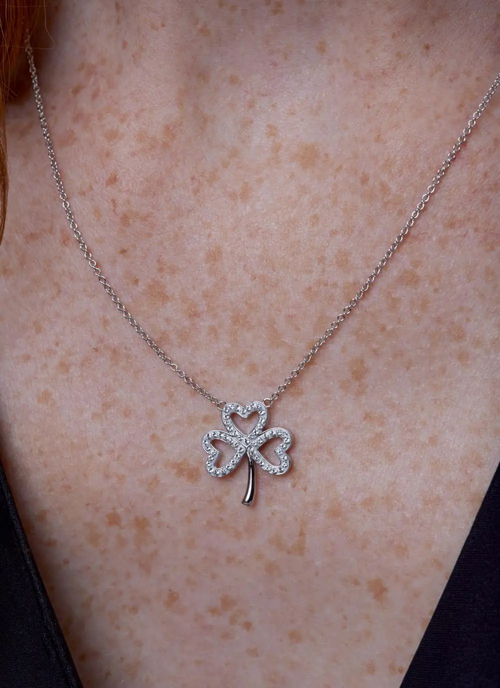 Décolletage shot of Sterling Silver Open Shamrock Pendant With Swarovski Crystals