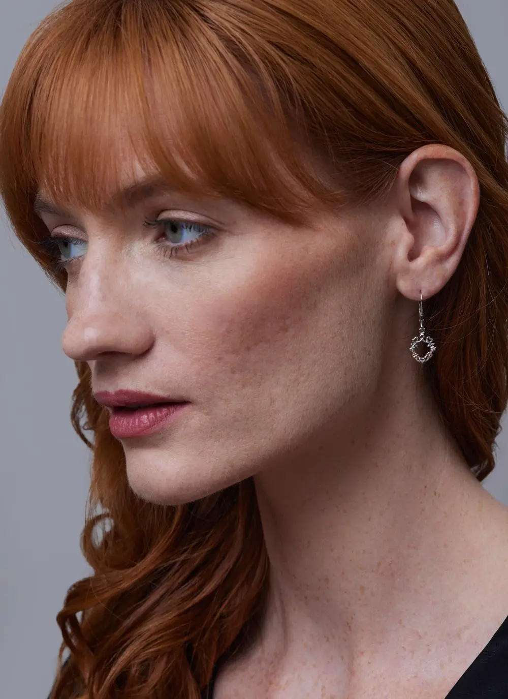 Red haired model wearing Sterling Silver Shamrock Claddagh Heart Earrings
