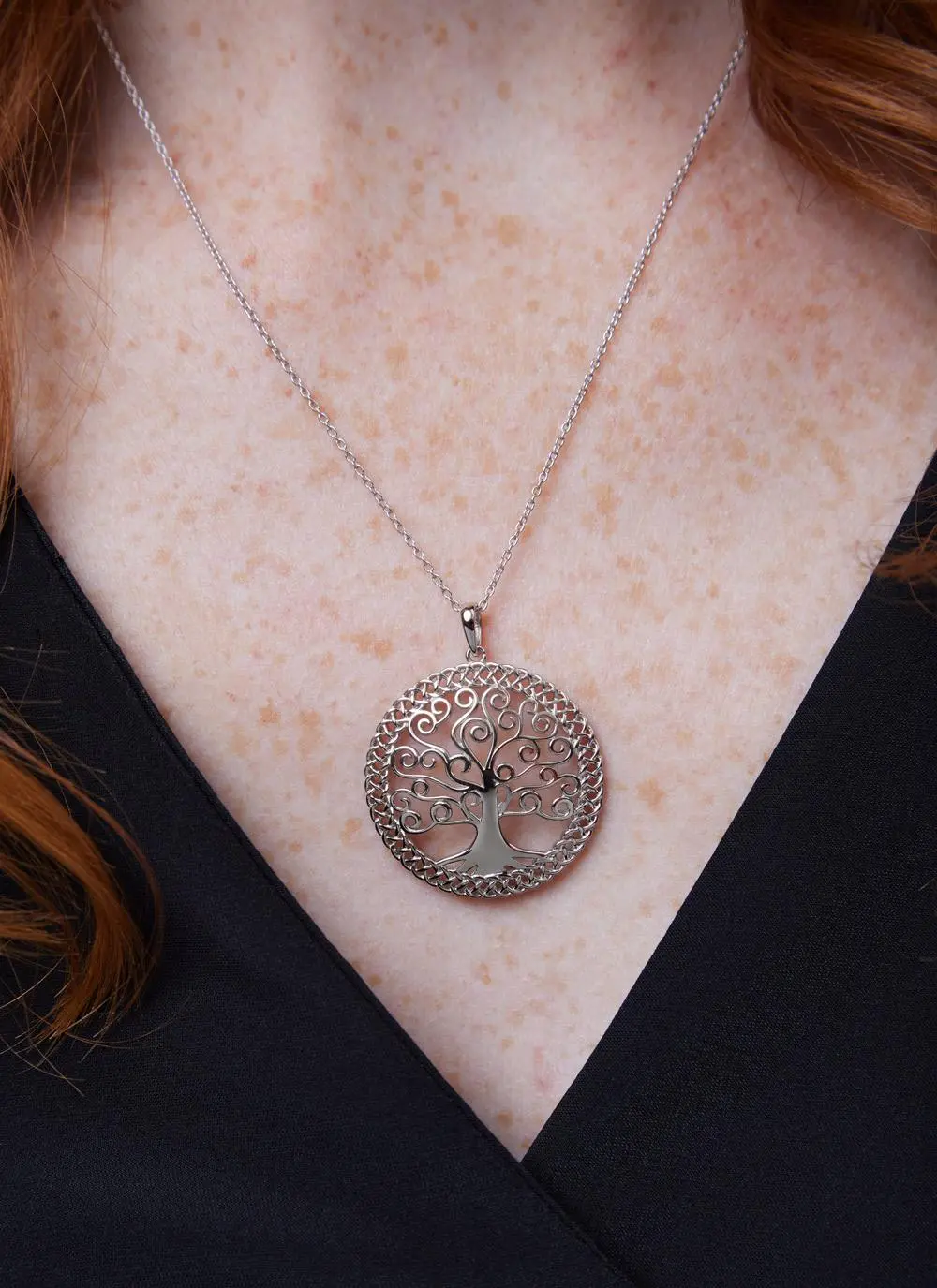 Décolletage shot of red haired woman wearing Sterling Silver Tree of Life Pendant