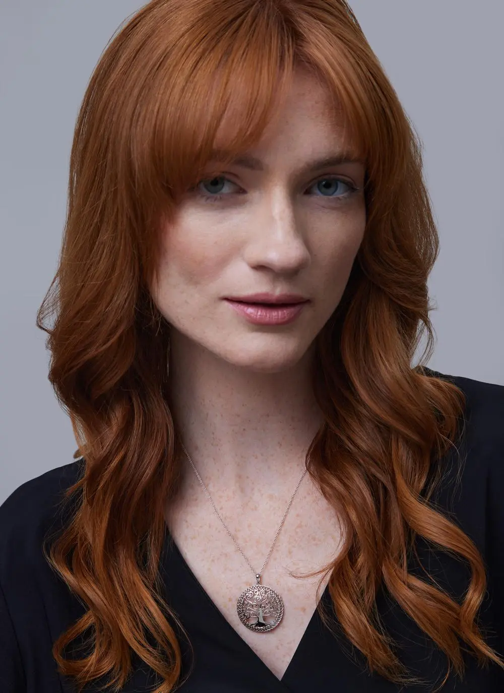 Head shot of red haired woman wearing Sterling Silver Tree of Life Pendant
