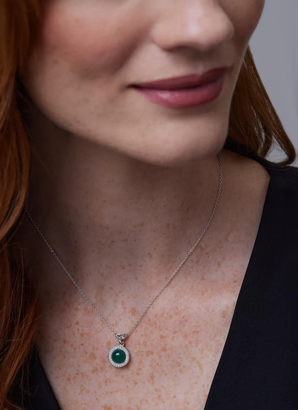 Close up of red haired model wearing Sterling Silver Trinity Knot Pendant with Agate 