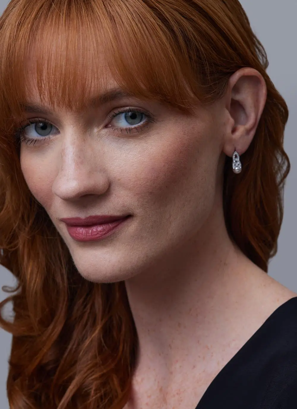 Red haired model wearing Sterling Silver Trinity Knot Pearl Earrings with Swarovski Crystal