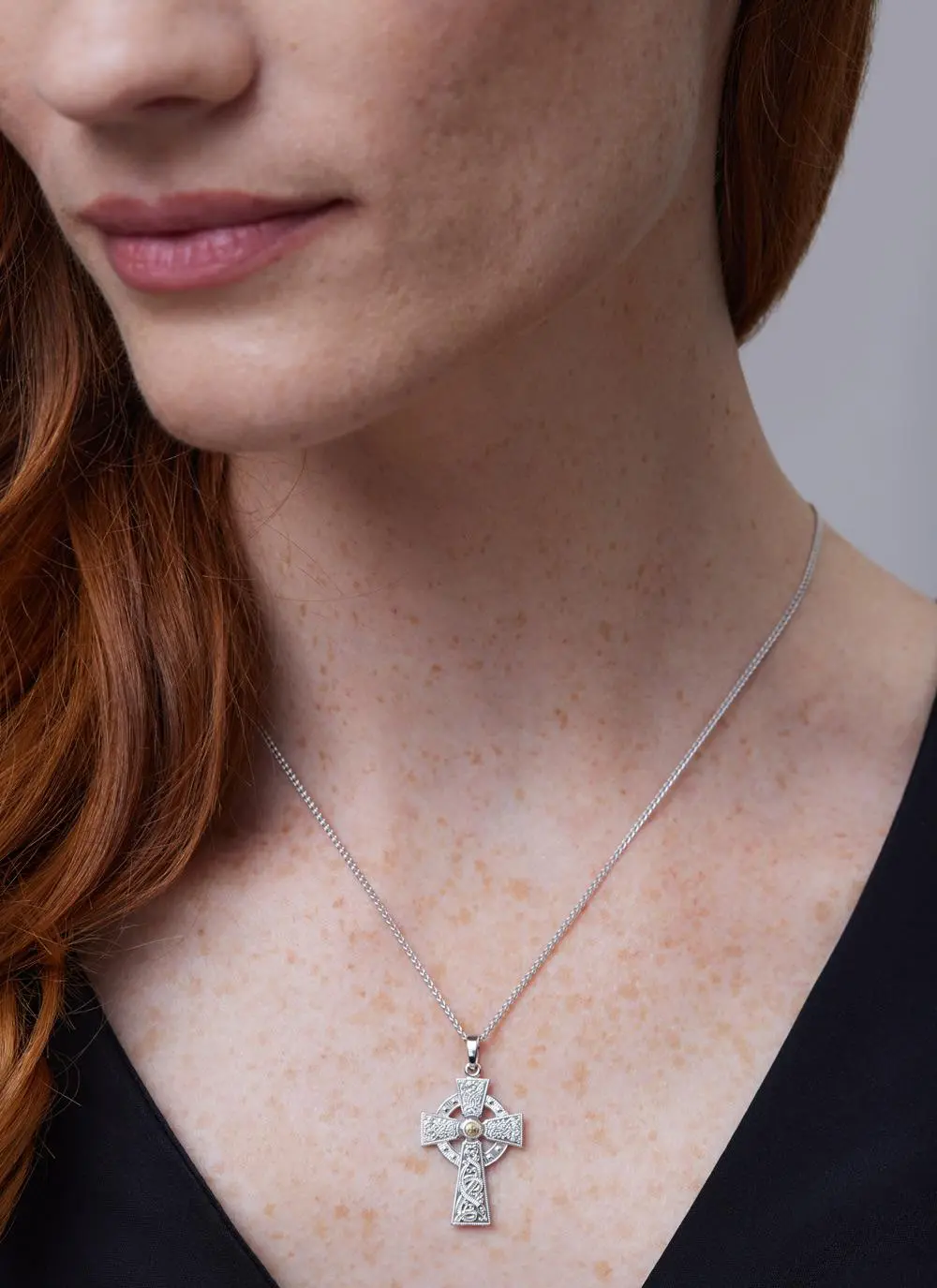 Close up shot of red haired model wearing Sterling Silver Warrior Shield Cross