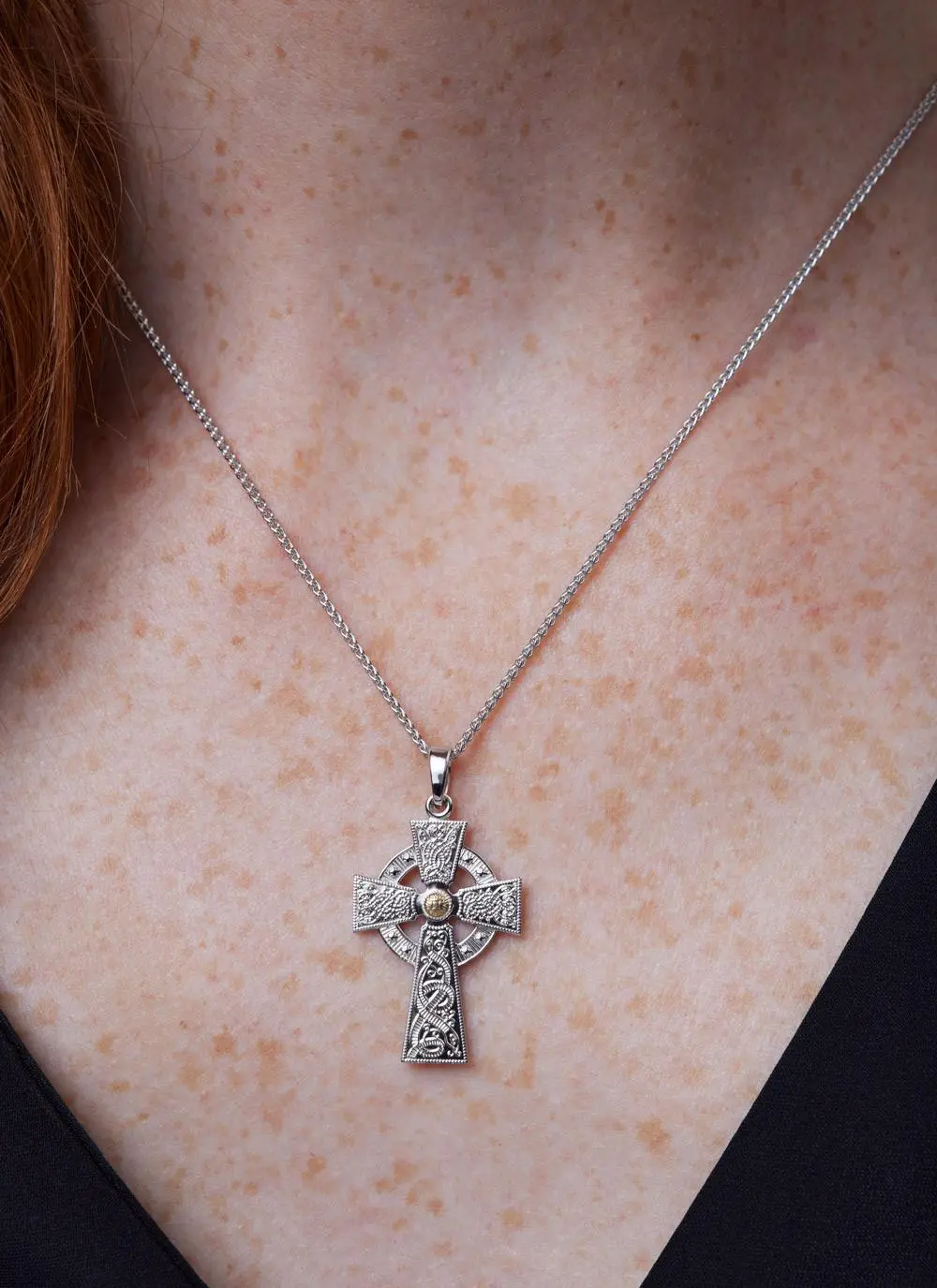 Decolletage shot of Sterling Silver Warrior Shield Cross