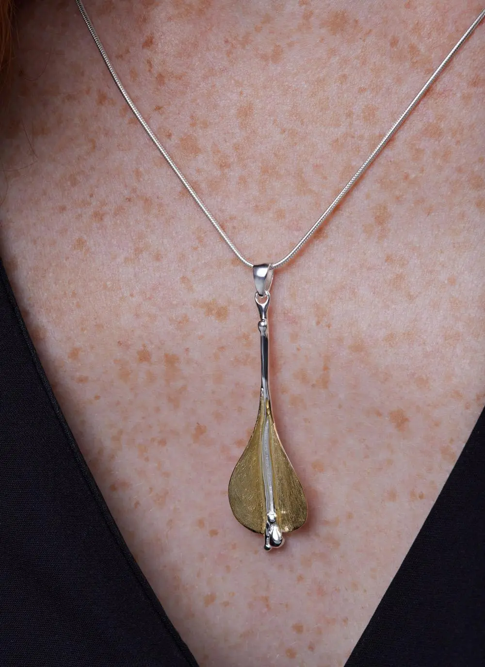 Decolletage shot of Two Tone Lily Pendant