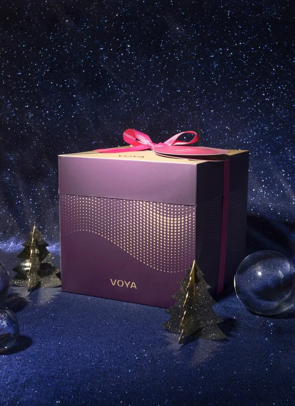 Voya Christmas Gift Set packaging against purple glittery festive background